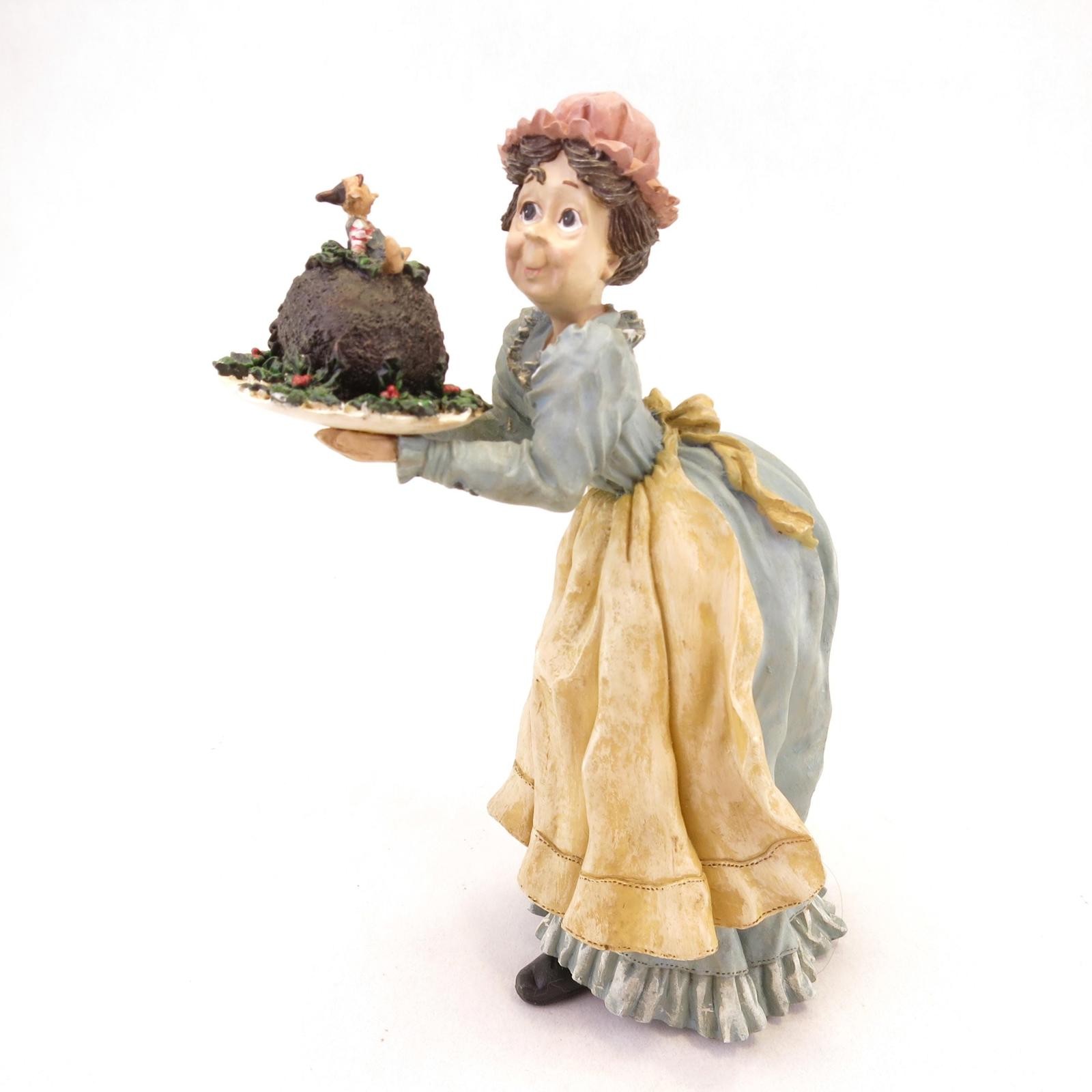 Quirky Woman Figure Holding a Elaborate Christmas Elf Cake 6.75″