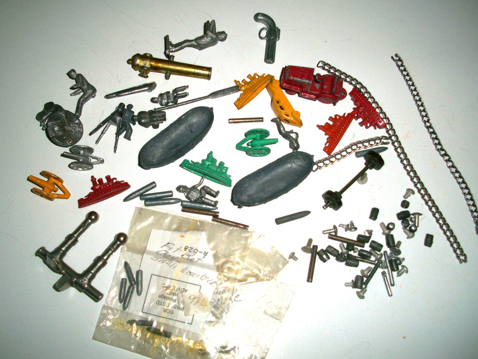 Junk drawer finds of Dinky toy parts and Britains ammo & Cracker Jack metal toys