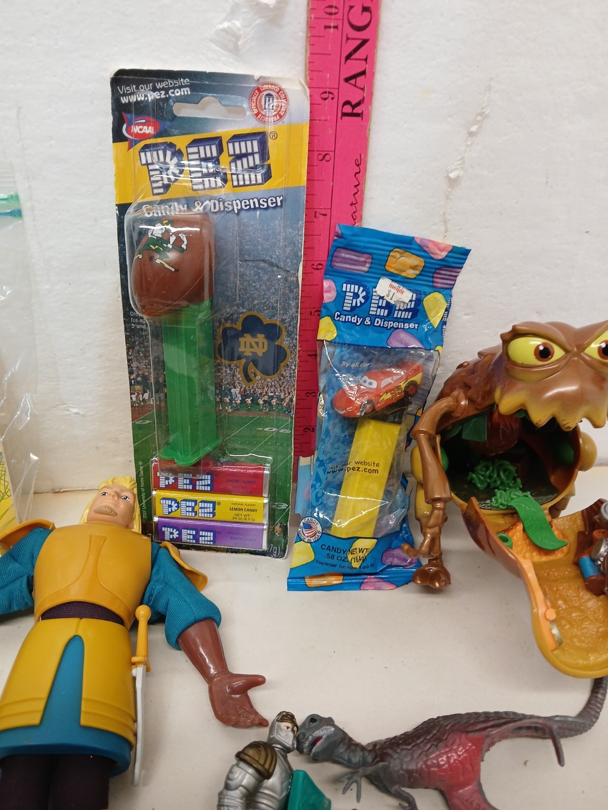 Vintage Toy Junk Drawer Lot PEZ Disney Cars Eeyore Figures Marbles Airplane